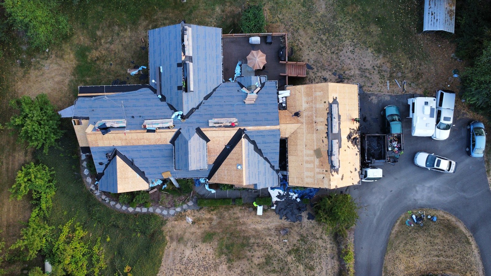 Drone view of a full re-deck and underlayment in progress on a large home